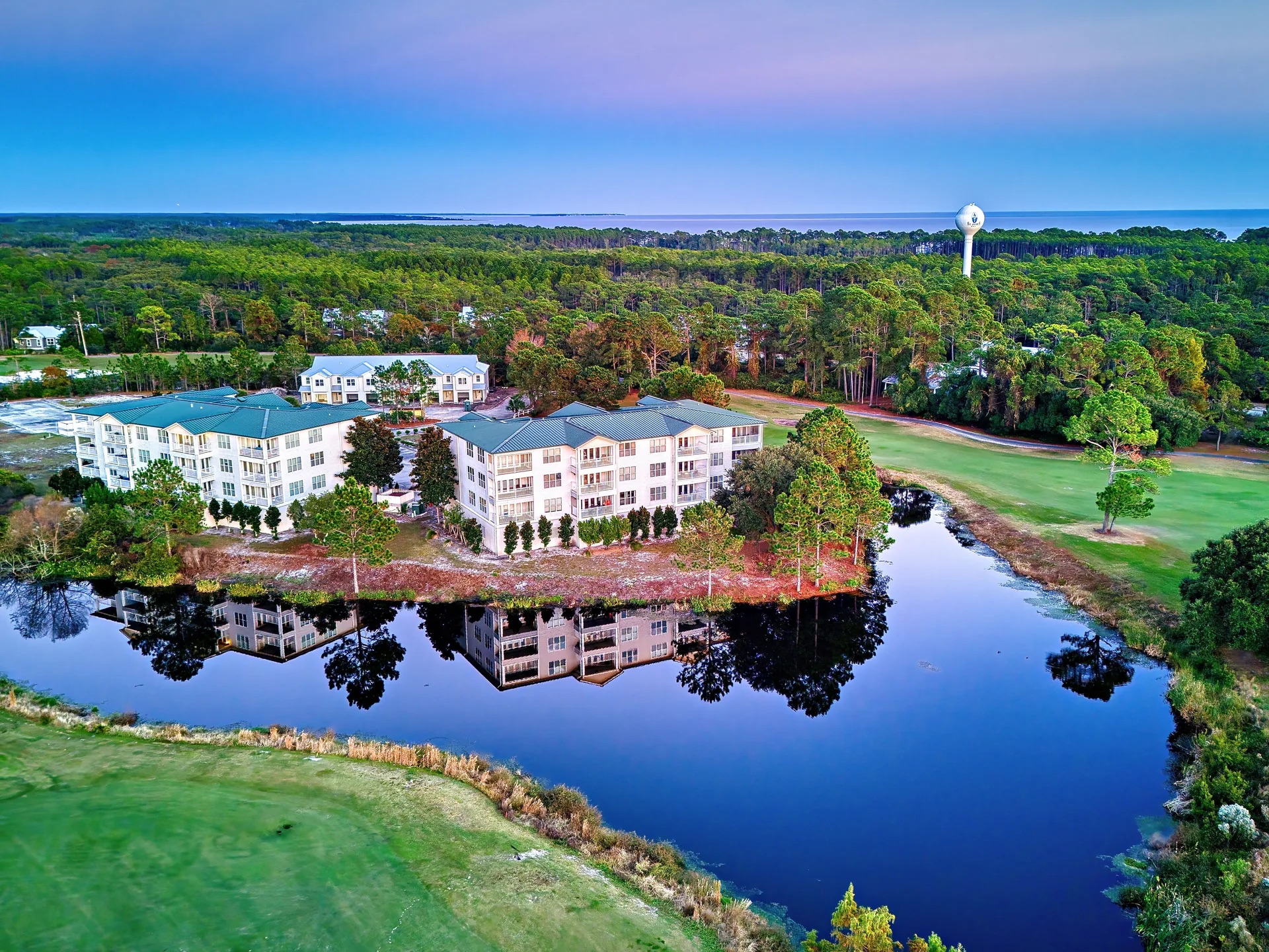 Aerial view of the golf resort condominiums beside the pond at St. James Bay