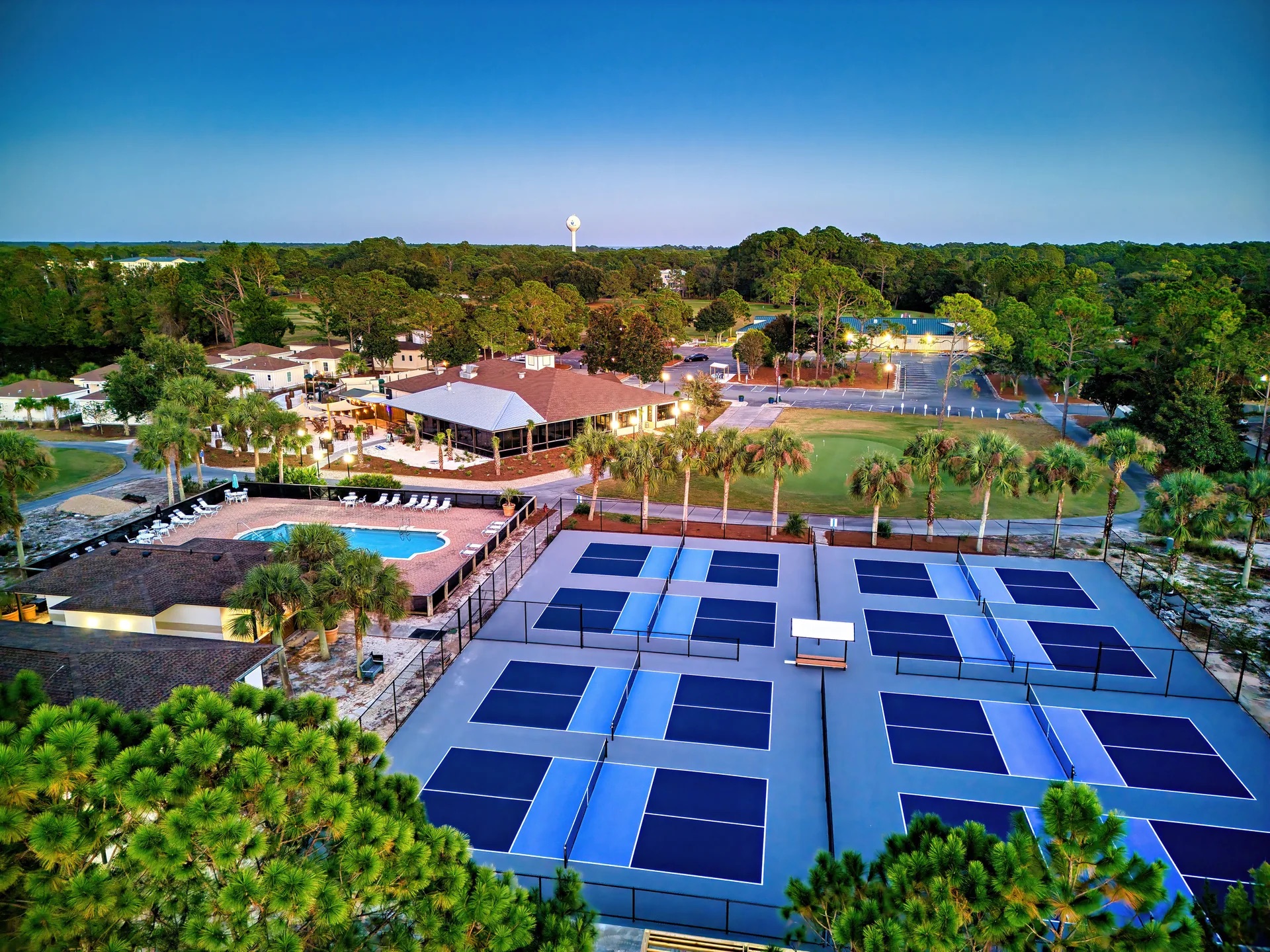 Aerial view of resort amenities — pickleball courts, pool, and clubhouse — at St. James Bay