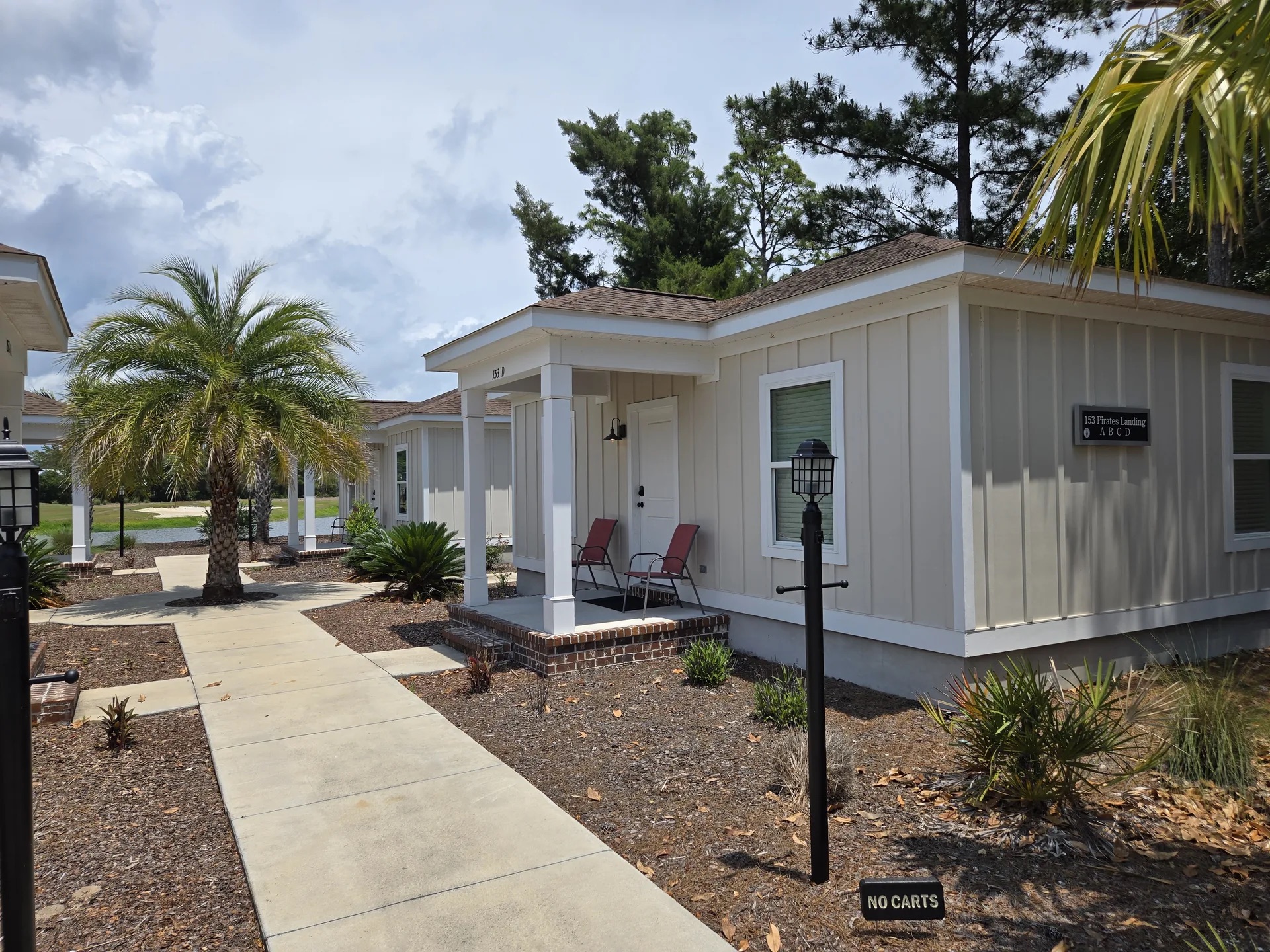 Exterior of the Clubhouse Villas with palm trees in Carrabelle FL