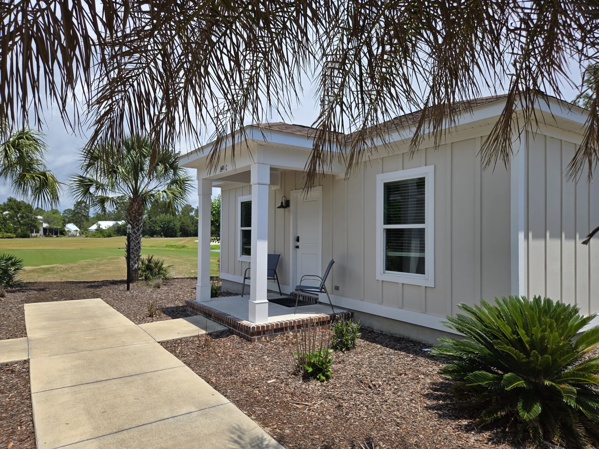Clubhouse Villa exterior with covered porch overlooking the golf course at St. James Bay
