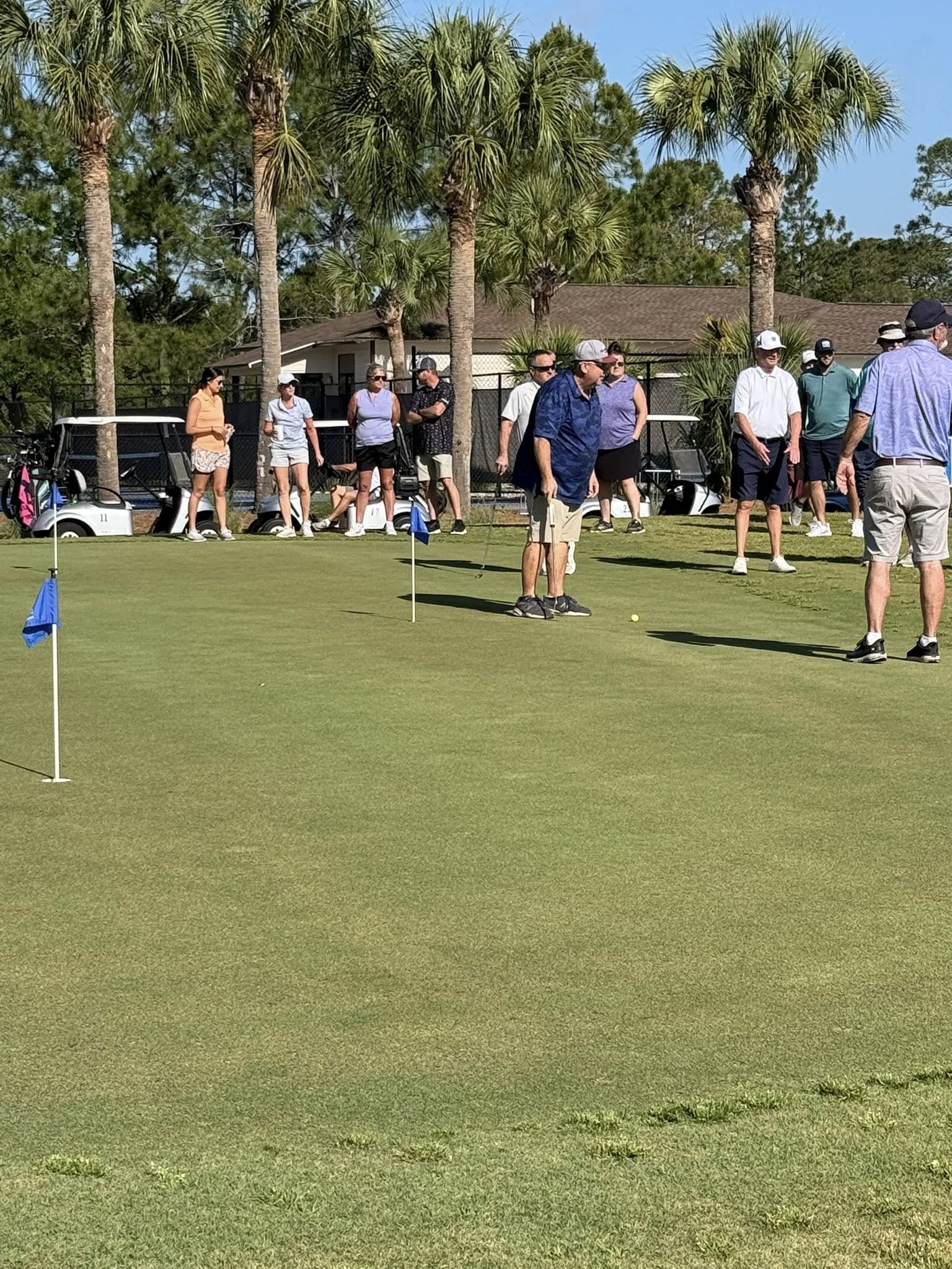 Golfers practicing on the putting green at St. James Bay